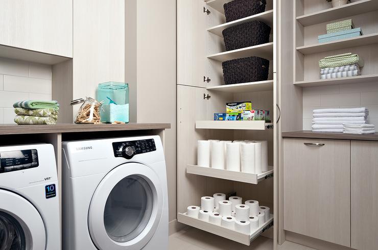 custom laundry room with built-in cabinet and storage shelves